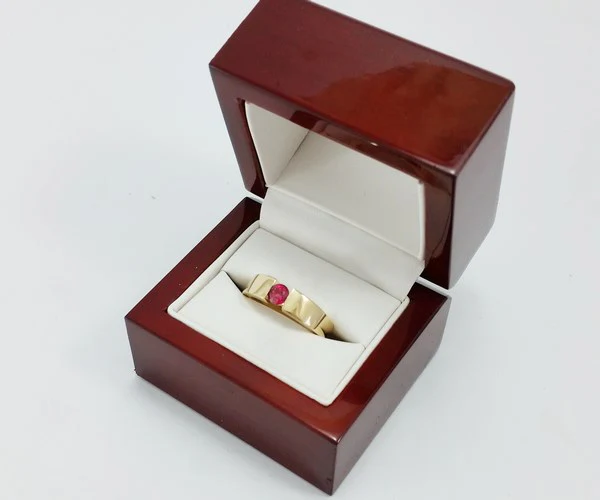 ring with ruby in its box