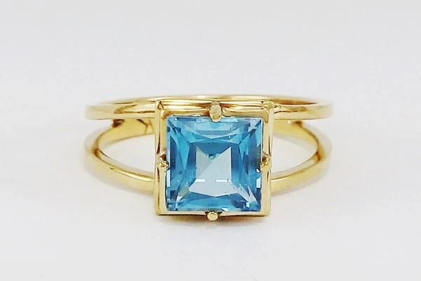 gold ring with large blue topaz