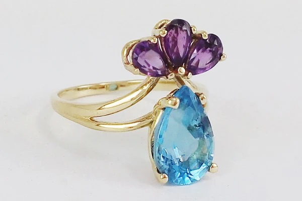 engagement ring featuring a blue topaz stone