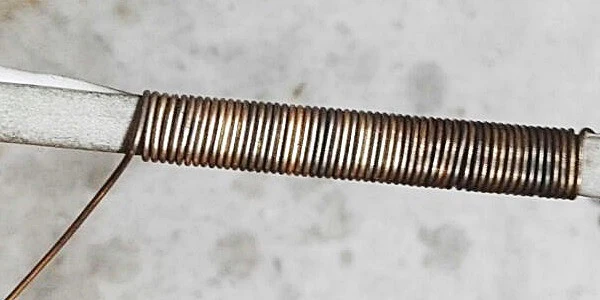 gold wire wrapped around a mandrel to form a chain